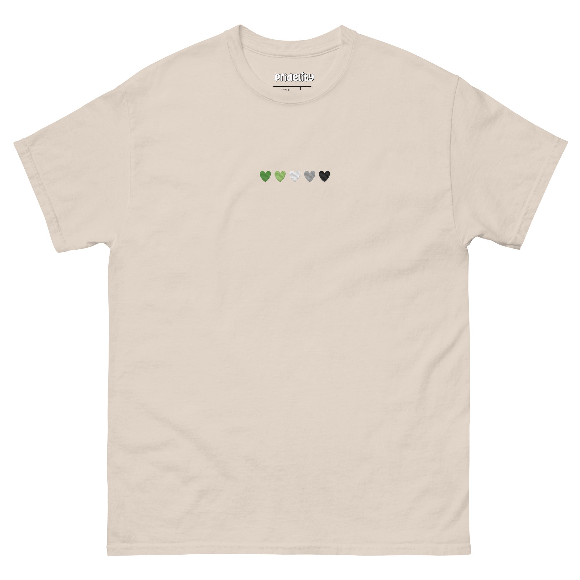 The Aromantic Love T-Shirt by Pridelity is cream-colored and features a row of small hearts across the chest in green, light green, white, gray, and black.