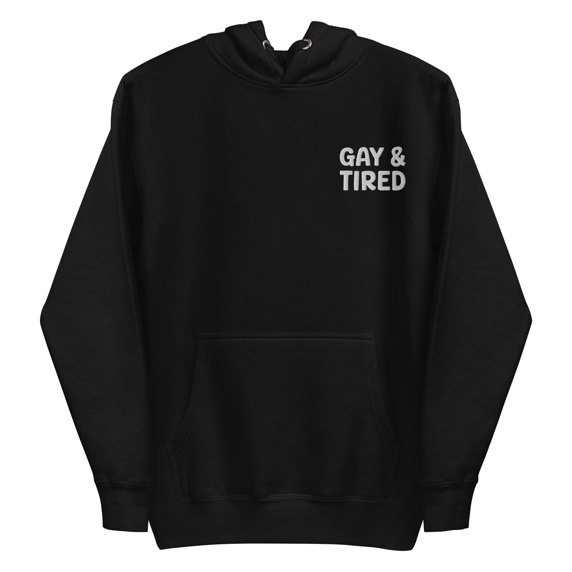 The Gay & Tired Hoodie by Pridelity is a black pride hoodie featuring white text on the upper left side that reads 