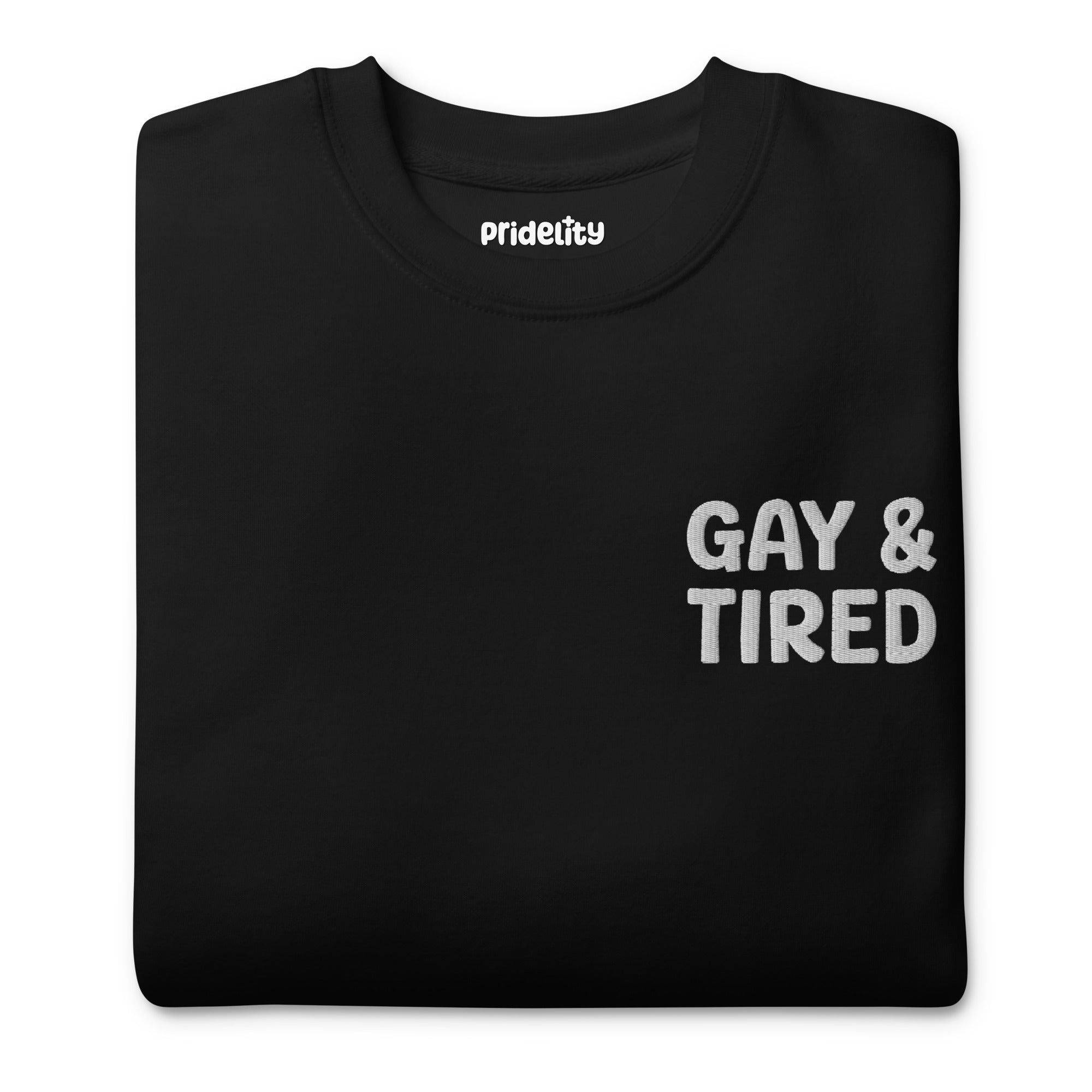 A black Gay & Tired Sweatshirt by Pridelity, featuring bold white text on the upper left side, ideal for those who love expressing pride through their rainbow-themed apparel.