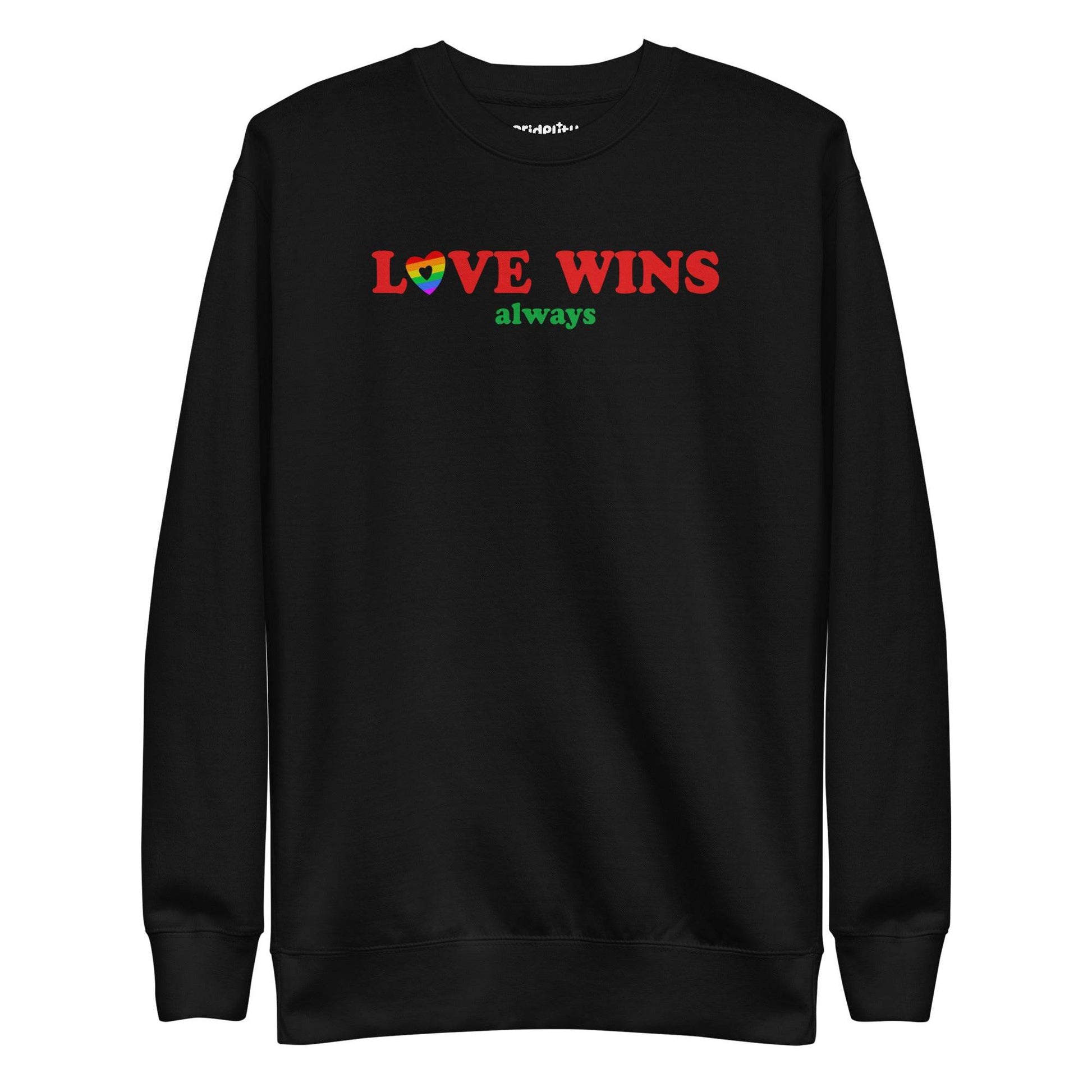 Introducing the "Love Wins, Always Sweatshirt" by Pridelity. This white sweatshirt prominently displays the bold red and green phrase "LOVE WINS always," with a unique twist: the "O" in "LOVE" is crafted into a vibrant rainbow-colored heart. It’s an ideal choice for anyone who embraces love with rainbow-inspired apparel.