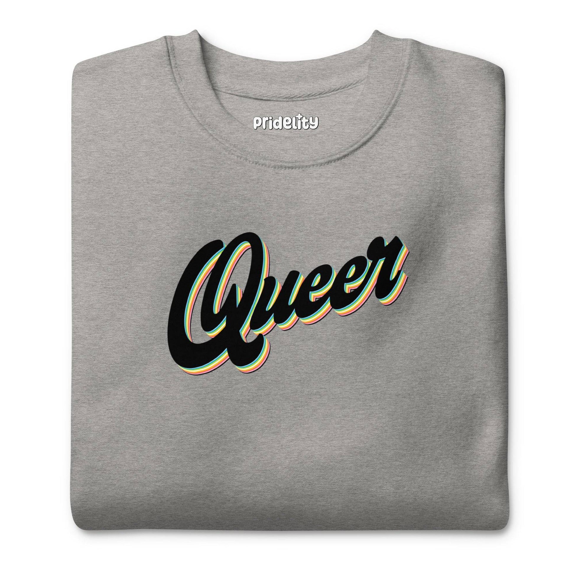 The Carbon Grey Queer Sweatshirt from Pridelity's pride collection showcases the word "Queer" in a stylized, cursive black font with white and yellow outlines across the chest.