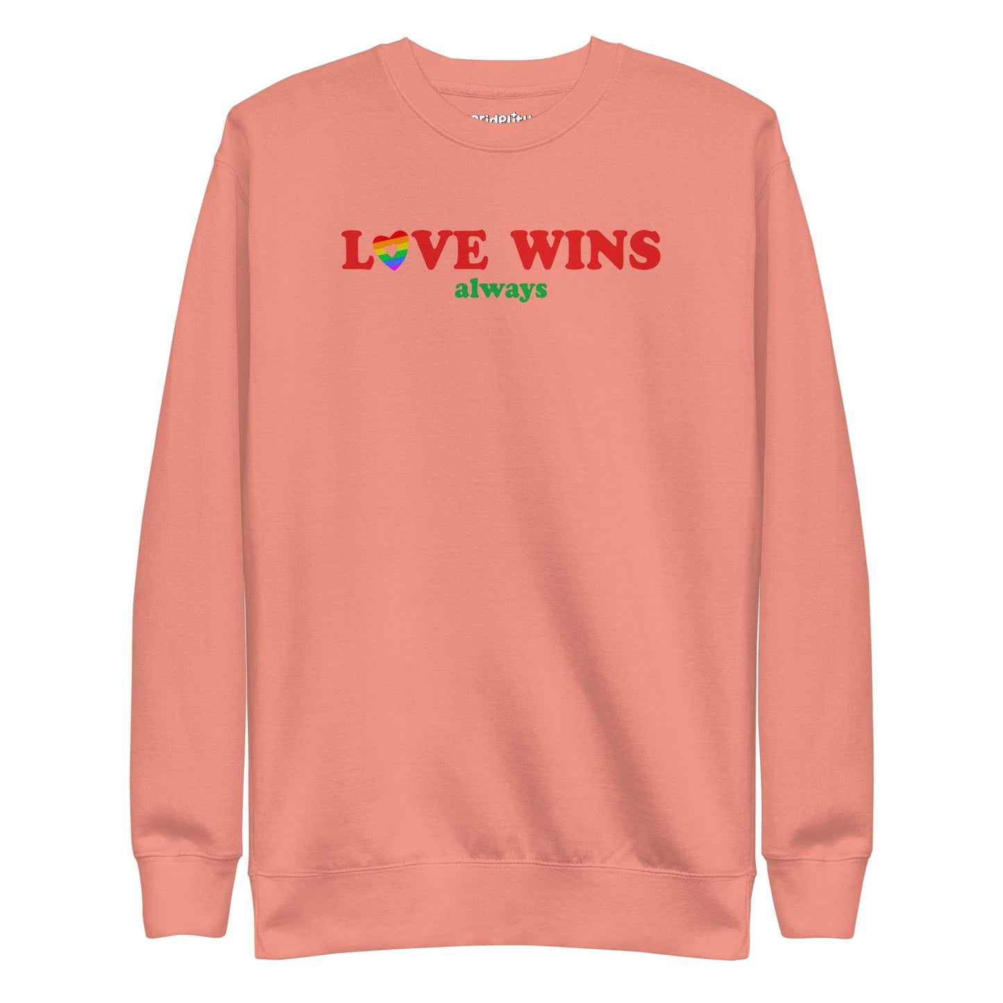 Introducing the "Love Wins, Always Sweatshirt" by Pridelity. This white sweatshirt prominently displays the bold red and green phrase "LOVE WINS always," with a unique twist: the "O" in "LOVE" is crafted into a vibrant rainbow-colored heart. It’s an ideal choice for anyone who embraces love with rainbow-inspired apparel.