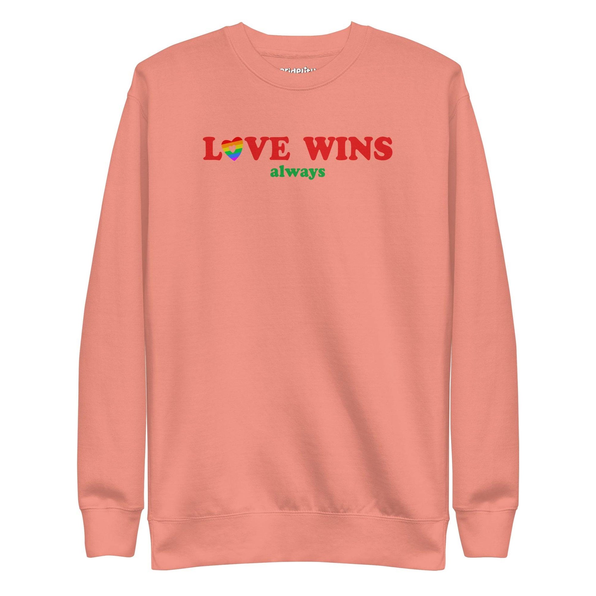 Introducing the "Love Wins, Always Sweatshirt" by Pridelity. This white sweatshirt prominently displays the bold red and green phrase "LOVE WINS always," with a unique twist: the "O" in "LOVE" is crafted into a vibrant rainbow-colored heart. It’s an ideal choice for anyone who embraces love with rainbow-inspired apparel.