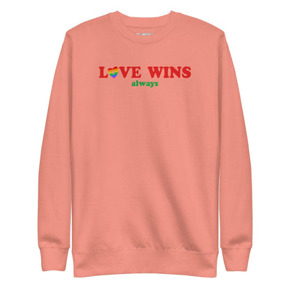 Introducing the "Love Wins, Always Sweatshirt" by Pridelity. This white sweatshirt prominently displays the bold red and green phrase "LOVE WINS always," with a unique twist: the "O" in "LOVE" is crafted into a vibrant rainbow-colored heart. It’s an ideal choice for anyone who embraces love with rainbow-inspired apparel.