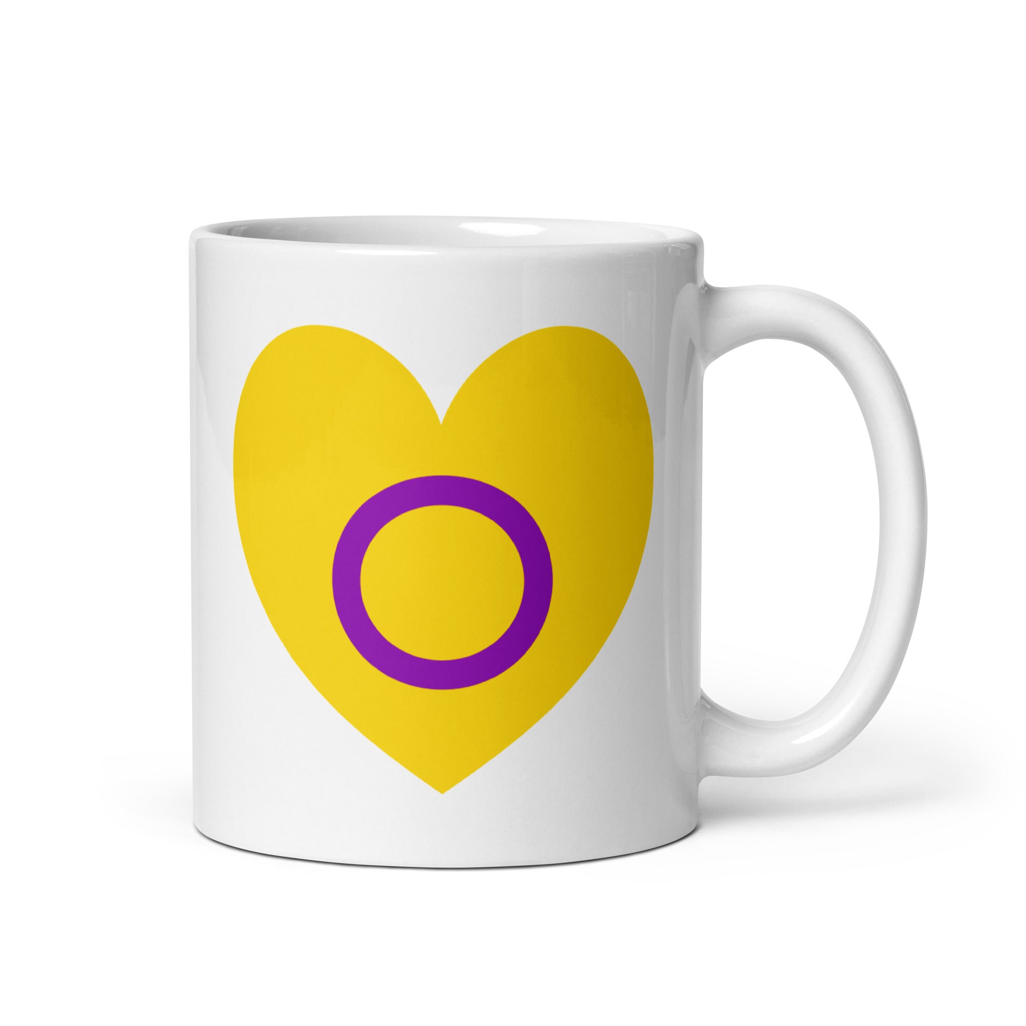 Introducing the Intersex Heart Mug from Pridelity's renowned 2025 pride collection. This white mug features a vibrant yellow heart with a purple circle at its center, and its elegantly placed handle on the right side adds to its charm.