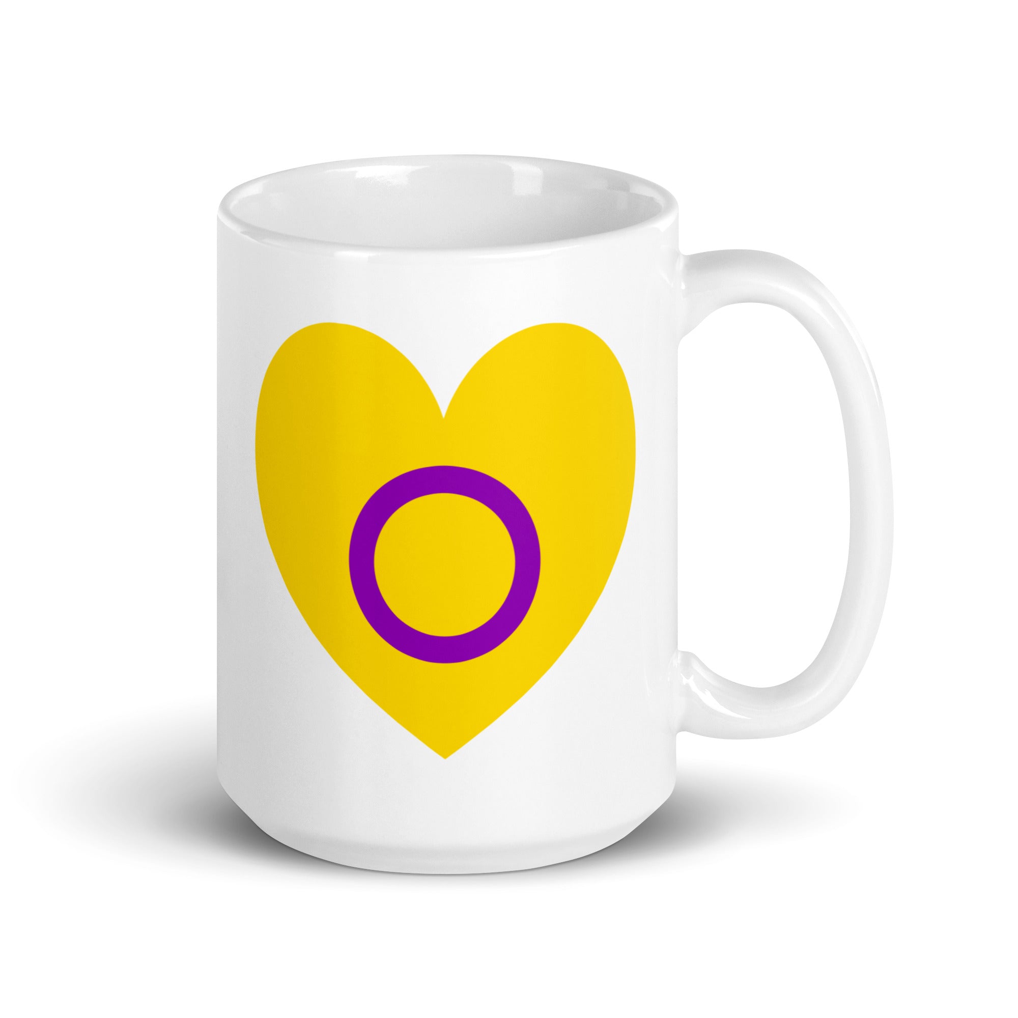 Introducing the Intersex Heart Mug from Pridelity's renowned 2025 pride collection. This white mug features a vibrant yellow heart with a purple circle at its center, and its elegantly placed handle on the right side adds to its charm.